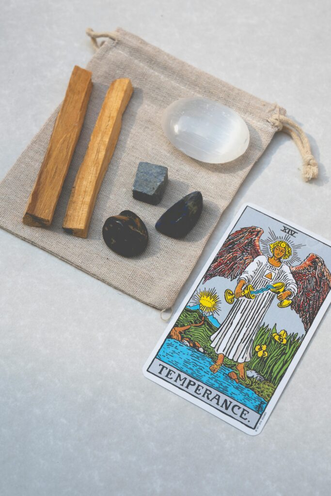 pexels-photo-7947799-7947799 Top view of tarot card and healing stones on a canvas bag, ideal for spiritual and alternative healing themes.