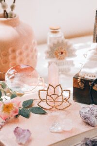 An artistic still life showcasing healing crystals and lotus decor in warm, ambient light.